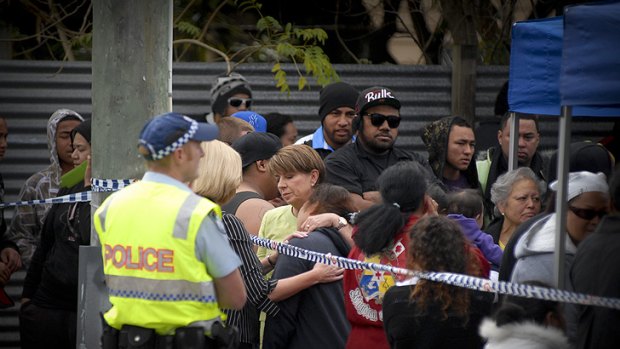 Premier Anna Bligh with family and friends of the 11 people who are believed to have been killed at a house fire overnight in Slacks Creek, south of Brisbane.