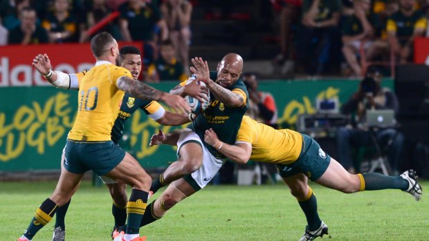 Bernard Foley tackles Lionel Mapoe during the Wallabies loss.