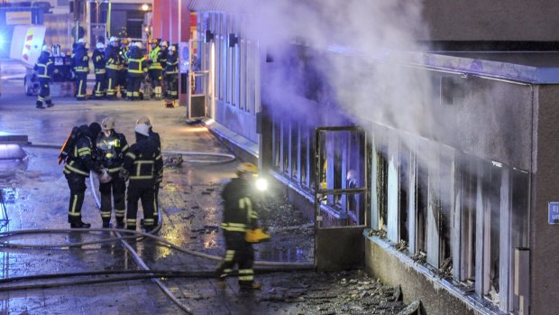 Firemen at work outside the mosque in Eskilstuna, Sweden,