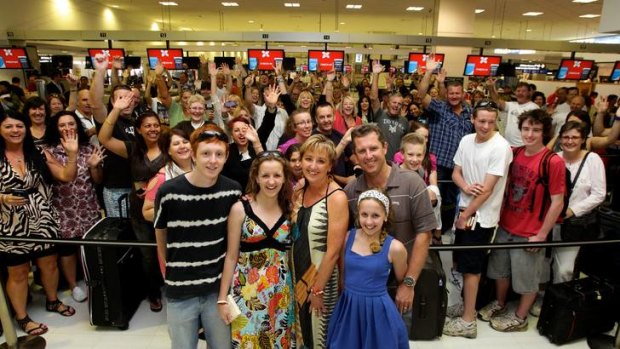 Julie-Anne Foster with her family (from left, children, Jake, 18, Natalie, 17, Keely, 13 and husband Darren) and some of her 251 friends check in for a three-day holiday in Kuala Lumpur after Julie-Anne won an AirAsia competition.