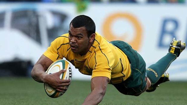 Kurtley Beale of the Wallabies dives over to score the first try.