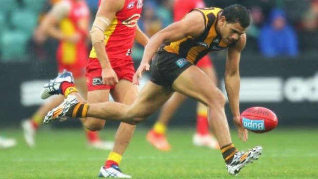 Cyril Rioli stretches for the ball and injures his hamstring against Gold Coast on Saturday.