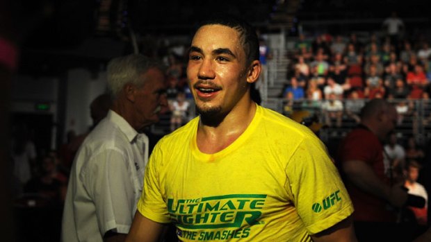 A delighted Robert Whittaker leaves the Gold Coast Convention and Exhibition Centre arena after defeating Brad Scott last December.