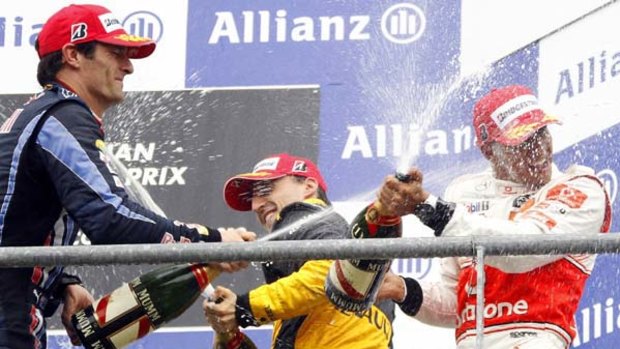 Mark Webber (left) with Robert Kubica and Lewis Hamilton on the podium after the Belgian Grand Prix.