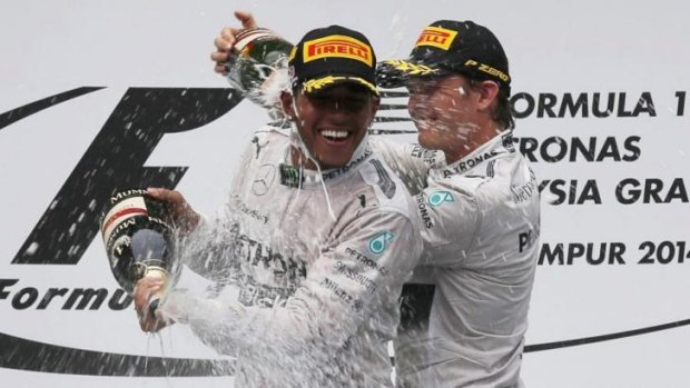 Pole-to-flag victory: Lewis Hamilton celebrates his victory in the Malaysian Grand Prix with teammate Nico Rosberg.