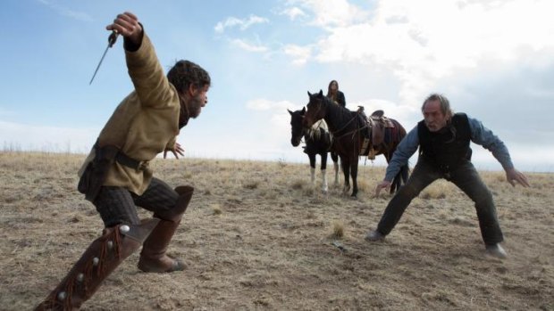 Tommy Lee Jones, right, does battle in <i>The Homesman</i>.