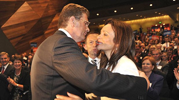 Ted Baillieu is embraced by his wife Robyn after the most important speech of his life as Tony Abbott waits to offer his congratulations.