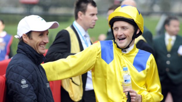 Jockey Damien Oliver (left) and the man who'll play him in <i>The Cup</i>, Stephen Curry, during filming at Flemington earlier this year.