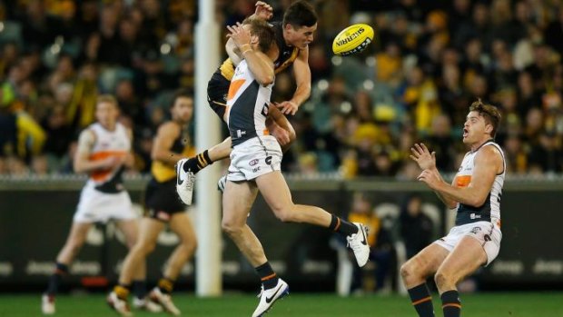 Rhys Palmer of the Giants takes a big hit from Nathan Gordon of the Tigers at the MCG on Saturday.