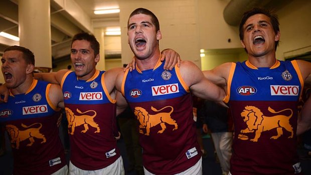 Jonathan Brown and Brisbane teammates sing their song after their surprise victory over Essendon.