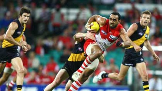 Out-rated ... Swan Adam Goodes tries to break a Richmond tackle last Saturday night. The game drew just 79,000 viewers in Sydney.
