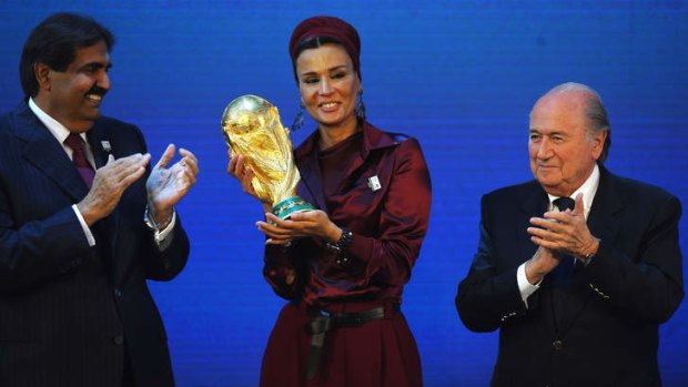 Fateful moment: The former emir of Qatar, Sheikh Hamad bin Khalifa Al-Thani, and Sheikha Mozah bint Nasser Al Missned are presented with the World Cup trophy by FIFA president Sepp Blatter after winning the bid for 2022 World Cup on December 2, 2010 in Zurich.