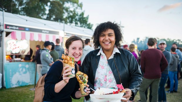 Caroline Delaisse and Alicia Wingyip enjoy some of the different foods the night markets has to offer.
