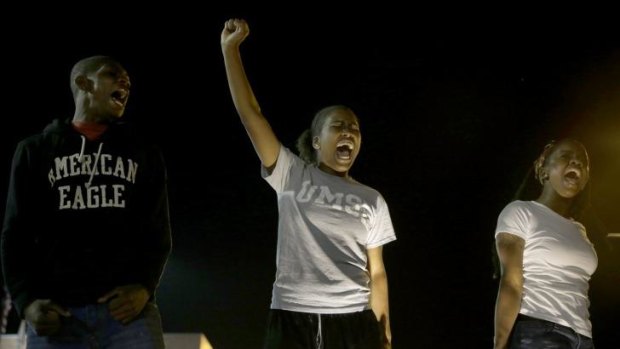 Anger ... A small group of people protest outside the police station on Friday in Ferguson, Missouri.