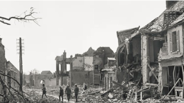 Four unidentified soldiers inspect the ruins of Villers-Bretonneux, April 1918.