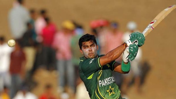 Man of the match, Umar Akmal, smites another boundary.