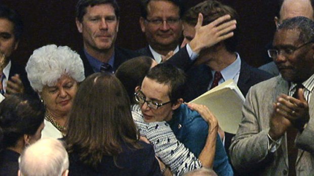 Welcome back: Shooting victim and congresswoman Gabrielle Giffords is surrounded by well-wishers on her return to Capitol Hill.