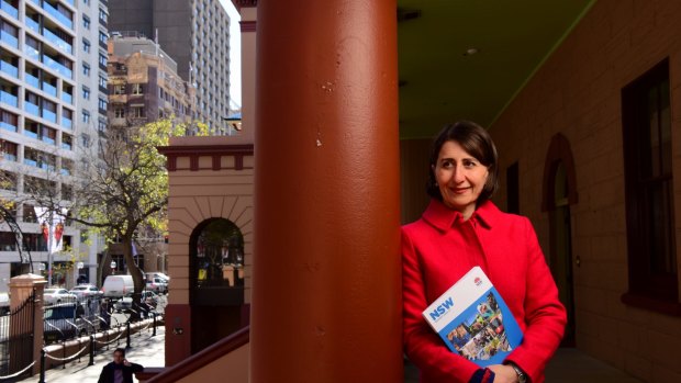 NSW State Treasurer Gladys Berejiklian poses with the 2016/17 budget papers outside State Parliament House. 

