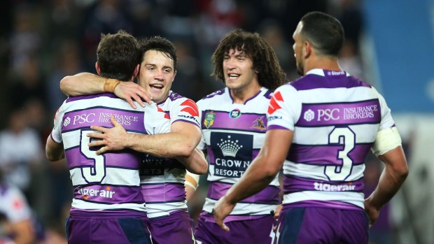 Job done: Melbourne Storm players embrace at full time in Sydney.