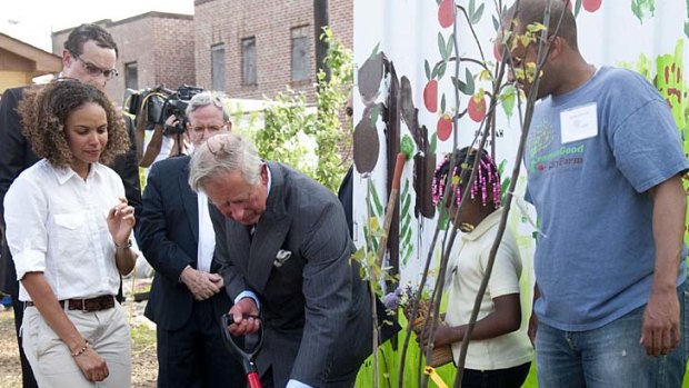 Prince Charles plants a tree at the Common Good City Farm.