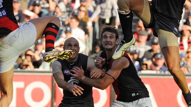 Captains engage: The Blues' Chris Judd and the Bombers' Jobe Watson fight for position.