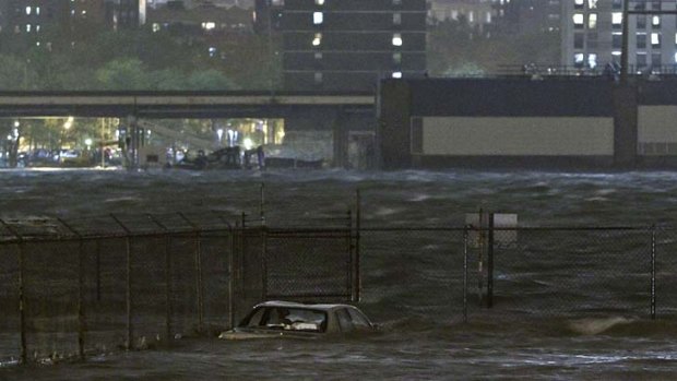 Burst its banks ... the East River overflows as Sandy sweeps through New York.