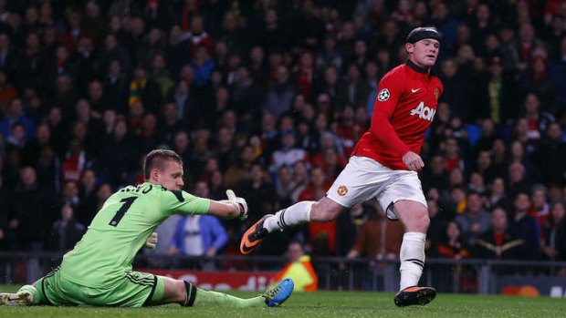Manchester United's Wayne Rooney shoots past Bayer Leverkusen's goalkeeper Bernd Leno.