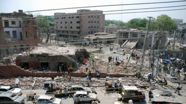 The scene of a destroyed police emergency response office building after a suicide car bomb attack in Lahore.