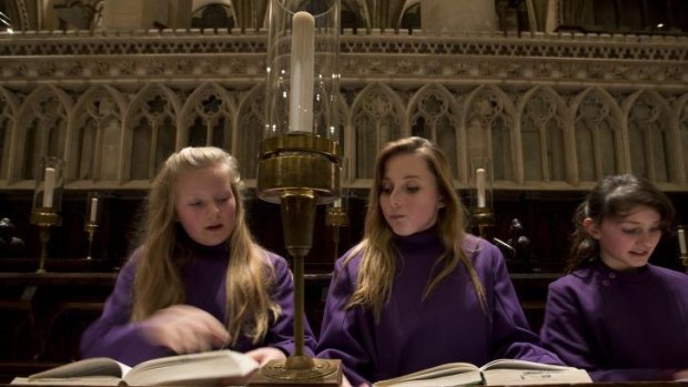 History girls: (From left) Choristers Abby Cox, Poppy Braddy and Chloe Chawner with their hymn books at  Canterbury Cathedral.