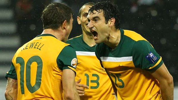 Look out, bellow: Mile Jedinak's in-your-face goal celebration with Harry Kewell.