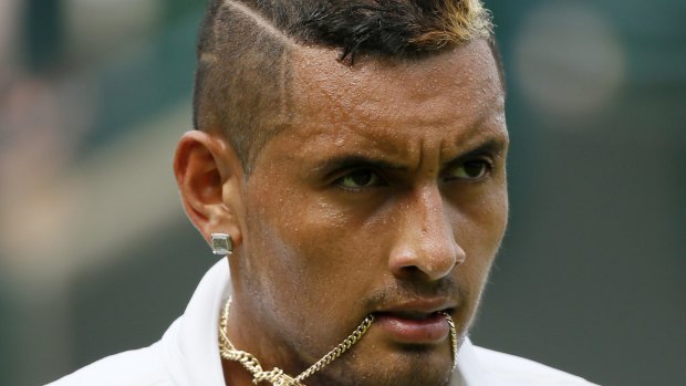 Fiery temper ... Nick Kyrgios holds his necklace in his mouth during his match against Juan Monaco of Argentina.