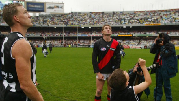 A decade ago: Nathan Buckley and James Hird at the coin toss for the 2002 ANZAC Day match.