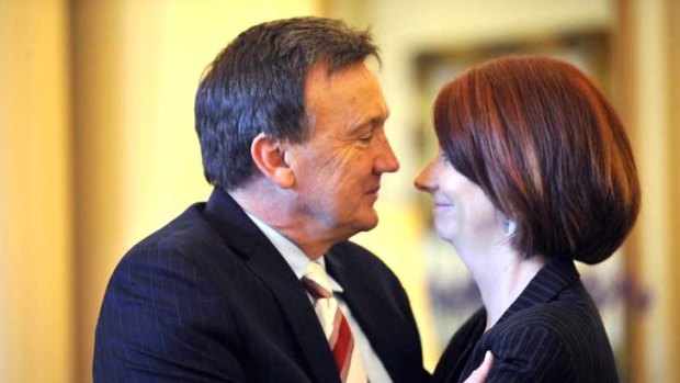 Tim Mathieson gazes lovingly at his leading lady Julia Gillard, after she was sworn in as prime minister on June 24 last year.