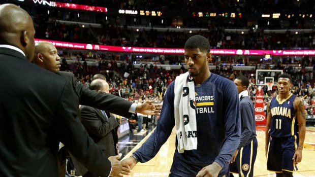 Indiana Pacers forward Paul George walks off the court after an NBA basketball game against the Chicago Bulls in Chicago. The Bulls won 110-94, handing the Pacers their first loss of the season.