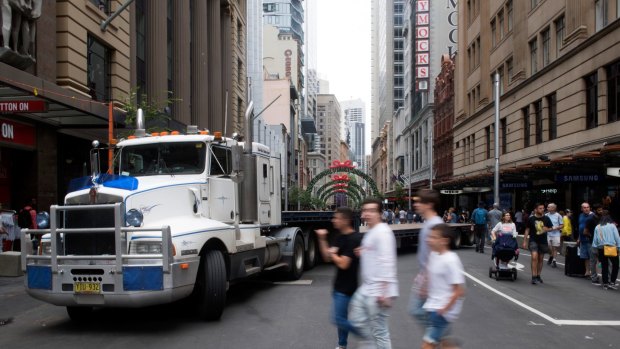 Semi-trailers and concrete bollards are used to block streets around Pitt Street Mall, George Street and Elizabeth Street during the Boxing Day sales in the Sydney CBD. 