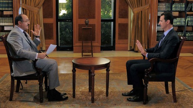 Not ready: Bashar al-Assad (right) in an interview with former Al-Jazeera journalist Ghassan bin Jiddo for the satellite channel al-Mayadeen.