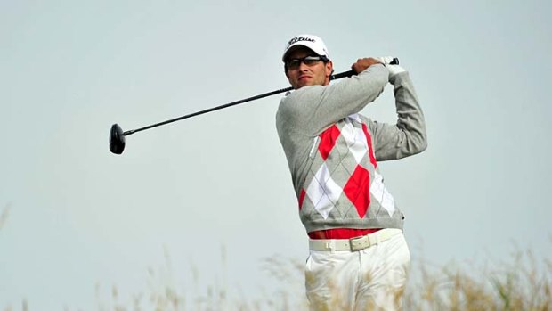 The leader ... Adam Scott of Australia watches his shot from the 11th tee during his third round on day three of the 2012 British Open Golf Championship at Royal Lytham.