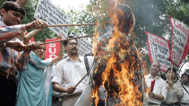 Protesters burn an effigy of the Indian prime minister.