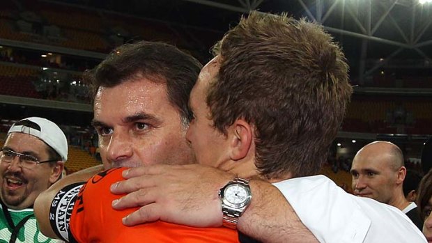 Ange Postecoglou and Roar skipper Matthew Smith embrace after the final whistle.