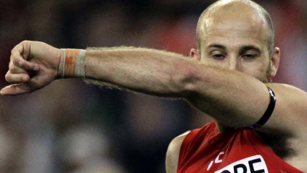 Sydney's Jarrad McVeigh kisses his armband in honour of his late daughter.