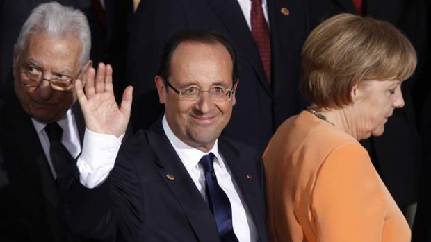 Togetherness only goes so far ... the French President, Francois Hollande, leaves the stage with the German Chancellor, Angela Merkel, at the summit in Chicago.