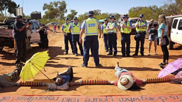 Protestors locked together block the road to Woodside's proposed gas factory at James Price Point on Western Australia's Kimberley coast.