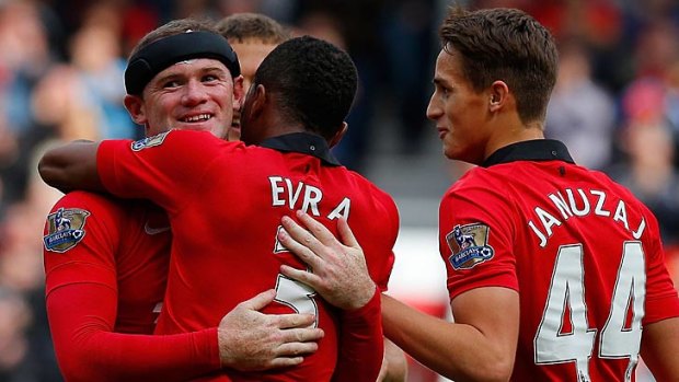 Welcome back: Wayne Rooney celebrates the sealer with Patrice Evra.