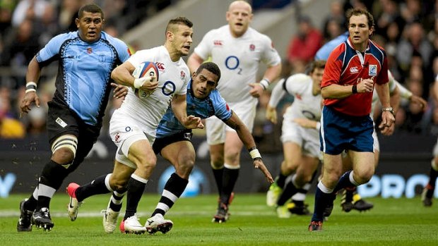 England's halfback Danny Care breaks away from the Fiji defence.