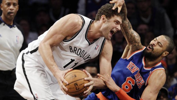 Brooklyn Nets centre Brook Lopez tangles with his New York Knicks counterpart Tyson Chandler in November. The rivalry between the clubs has grown this season following the Nets' switch to Brooklyn.