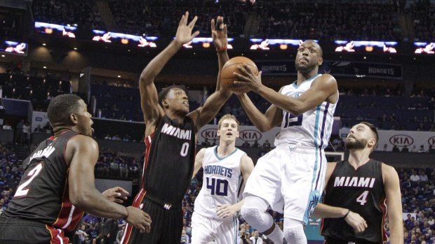 Going the distance: Kemba Walker drives through a trio of Heat players.