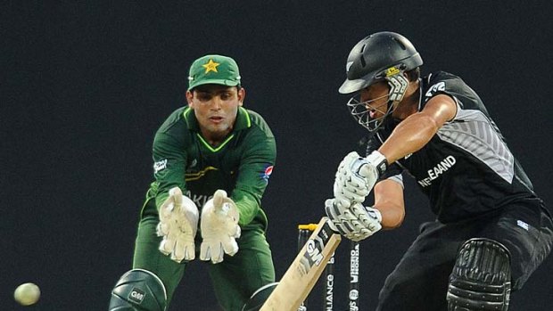 Ross Taylor guides a ball down to fine leg as wicketkeeper Kamran Akmal looks on.