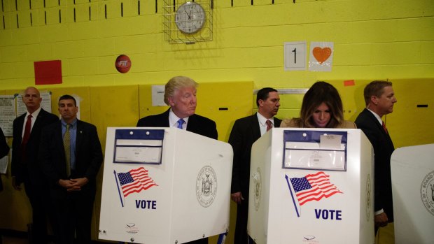 Republican presidential candidate Donald Trump looks at his wife Melania as they cast their votes.