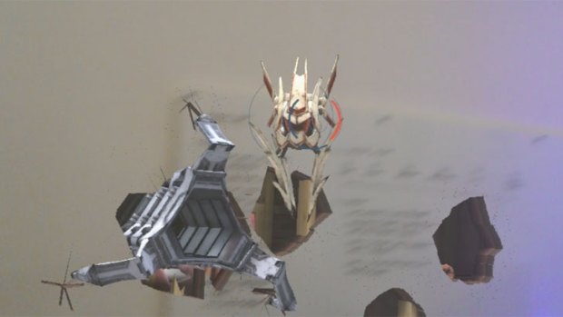 Flying robots burst through the office walls playing Robo Raid with the Hololens headset.