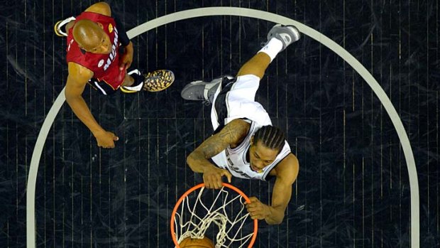 Kawhi Leonard #2 of the San Antonio Spurs dunks the ball against the Miami Heat.